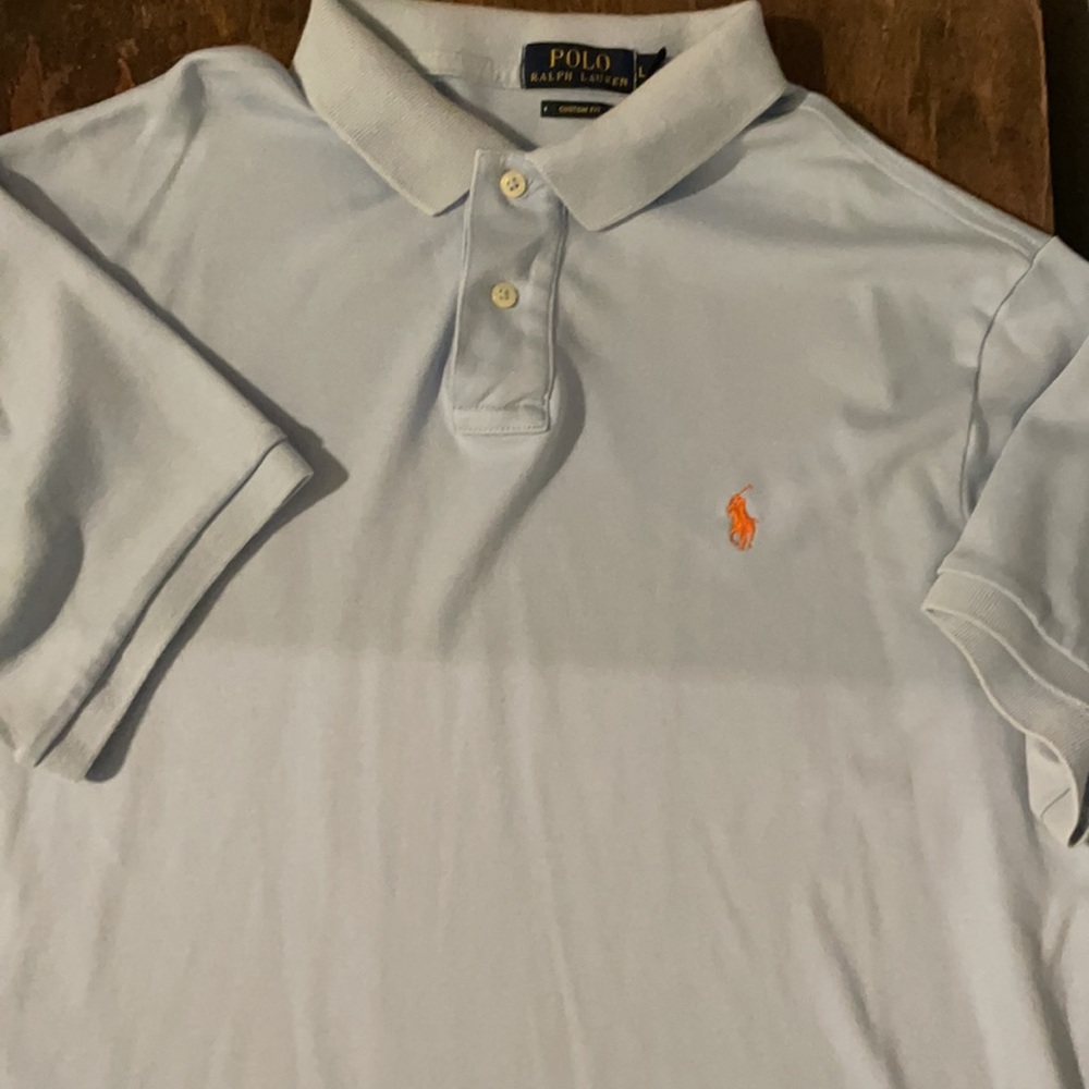 Light blue polo.